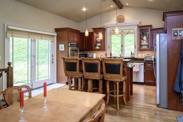 128 S Kent Rd, Kent, CT 06785 - kitchen featuring light wood-style floors, appliances with stainless steel finishes, a healthy amount of sunlight, and vaulted ceiling with beams