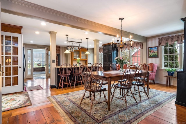 120 Boston Post Rd, Old Lyme, CT 06371 - dining room with ornamental molding, healthy amount of natural light, hardwood / wood-style flooring, and a chandelier