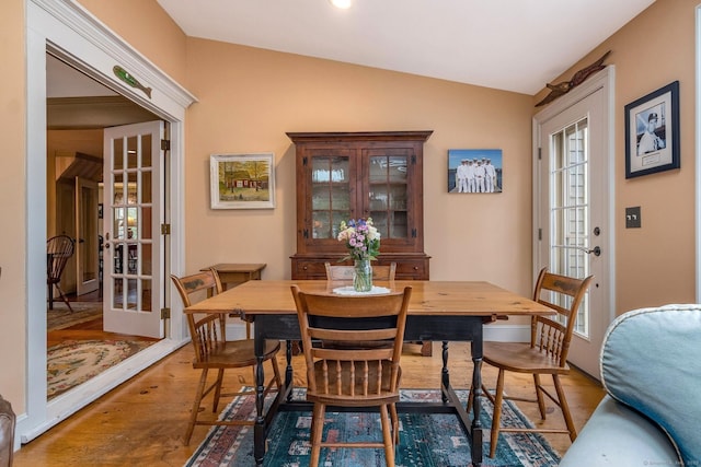 120 Boston Post Rd, Old Lyme, CT 06371 - dining space with french doors, vaulted ceiling, and wood finished floors