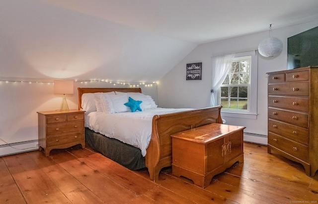 120 Boston Post Rd, Old Lyme, CT 06371 - bedroom featuring a baseboard heating unit, light wood finished floors, and vaulted ceiling