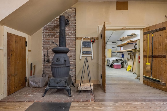 120 Boston Post Rd, Old Lyme, CT 06371 - unfurnished living room with a wood stove, lofted ceiling, and hardwood / wood-style flooring