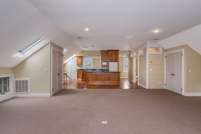 120 Boston Post Rd, Old Lyme, CT 06371 - kitchen with white appliances, open floor plan, carpet floors, lofted ceiling, and a skylight