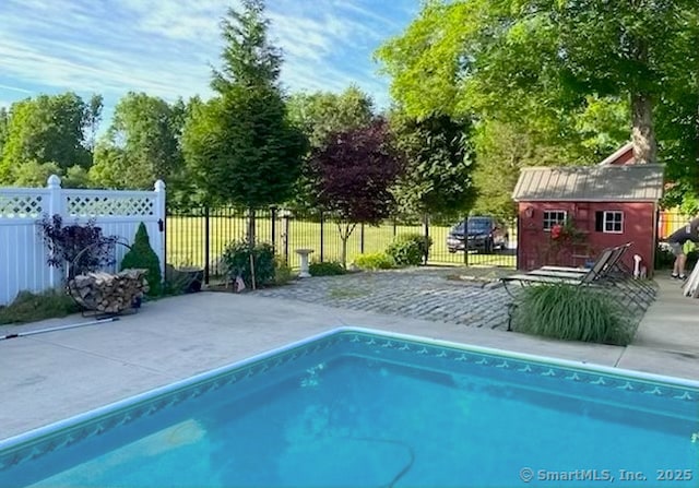 120 Boston Post Rd, Old Lyme, CT 06371 - view of swimming pool with an outbuilding, a patio, and view of wooded area