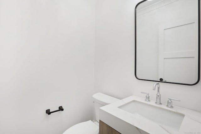 half bathroom with toilet and vanity