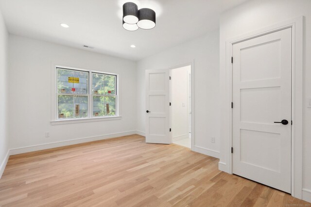 unfurnished bedroom with recessed lighting, light wood-style floors, baseboards, and visible vents