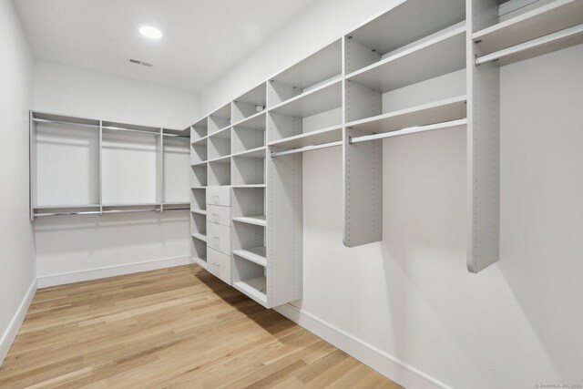 spacious closet with wood finished floors and visible vents
