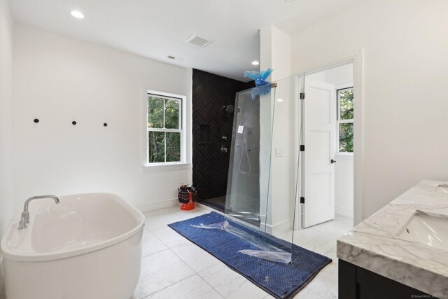 full bath featuring walk in shower, a freestanding bath, visible vents, and a wealth of natural light