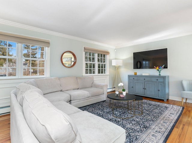 living area with crown molding, baseboards, wood finished floors, and baseboard heating
