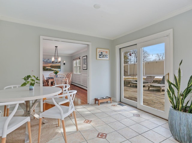 dining space featuring ornamental molding, a baseboard heating unit, light tile patterned flooring, and a notable chandelier