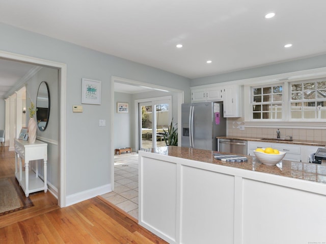 kitchen with tile countertops, appliances with stainless steel finishes, white cabinetry, and recessed lighting