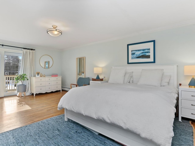 bedroom featuring a baseboard radiator, ornamental molding, wood finished floors, and access to exterior