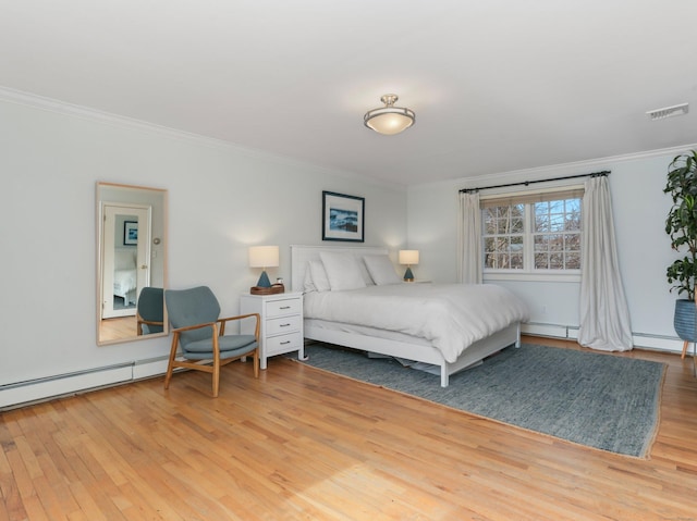 bedroom featuring a baseboard radiator, ornamental molding, wood finished floors, and visible vents