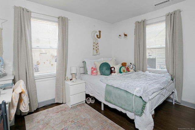 bedroom featuring visible vents and wood finished floors