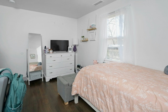 bedroom featuring visible vents and dark wood-type flooring