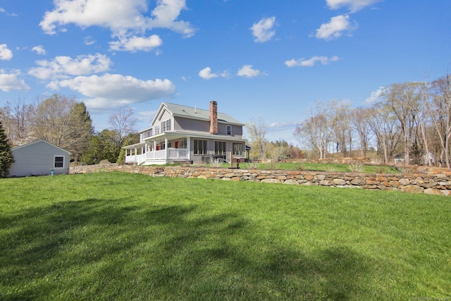 34 Kent Rd, Warren, CT 06754 - rear view of house featuring a chimney, a lawn, and a sunroom