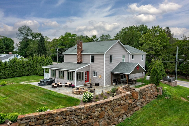 34 Kent Rd, Warren, CT 06754 - back of property featuring a fire pit, a patio area, a shingled roof, and a chimney