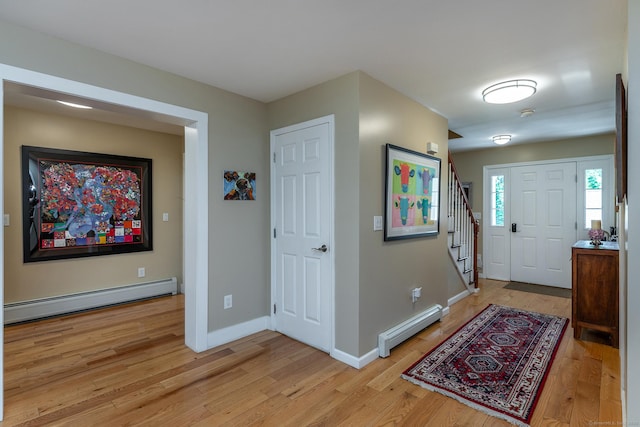 34 Kent Rd, Warren, CT 06754 - foyer featuring a baseboard heating unit, light wood finished floors, and stairs