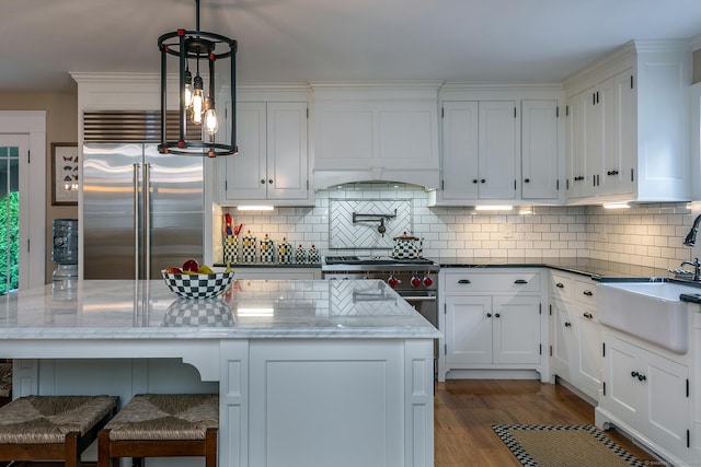 34 Kent Rd, Warren, CT 06754 - kitchen featuring high end appliances, custom exhaust hood, white cabinets, and decorative backsplash