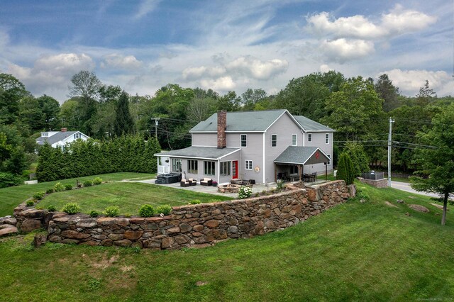 34 Kent Rd, Warren, CT 06754 - back of house featuring a patio, a chimney, an attached garage, and a yard