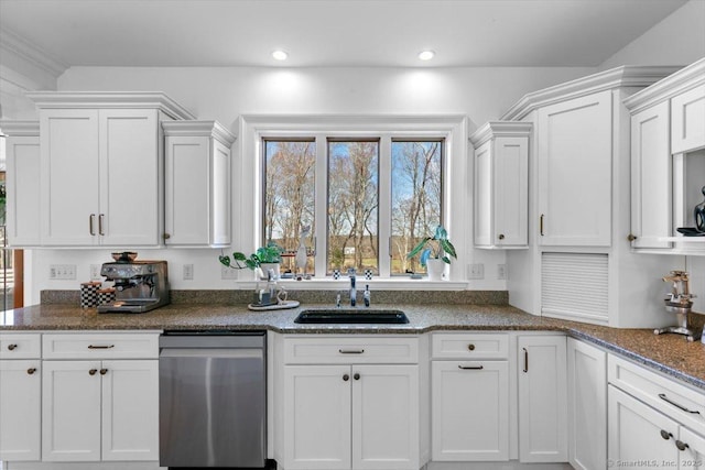 kitchen featuring dark stone countertops, recessed lighting, white cabinets, dishwasher, and a sink
