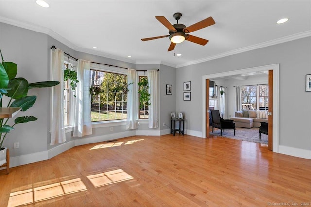 unfurnished living room featuring baseboards, a ceiling fan, crown molding, and wood finished floors
