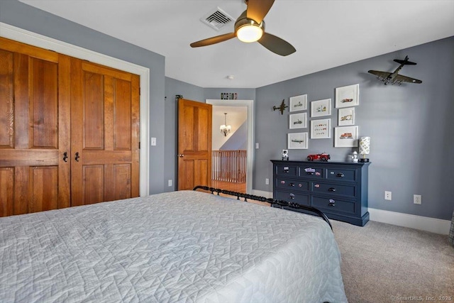 bedroom featuring carpet flooring, visible vents, baseboards, and a ceiling fan