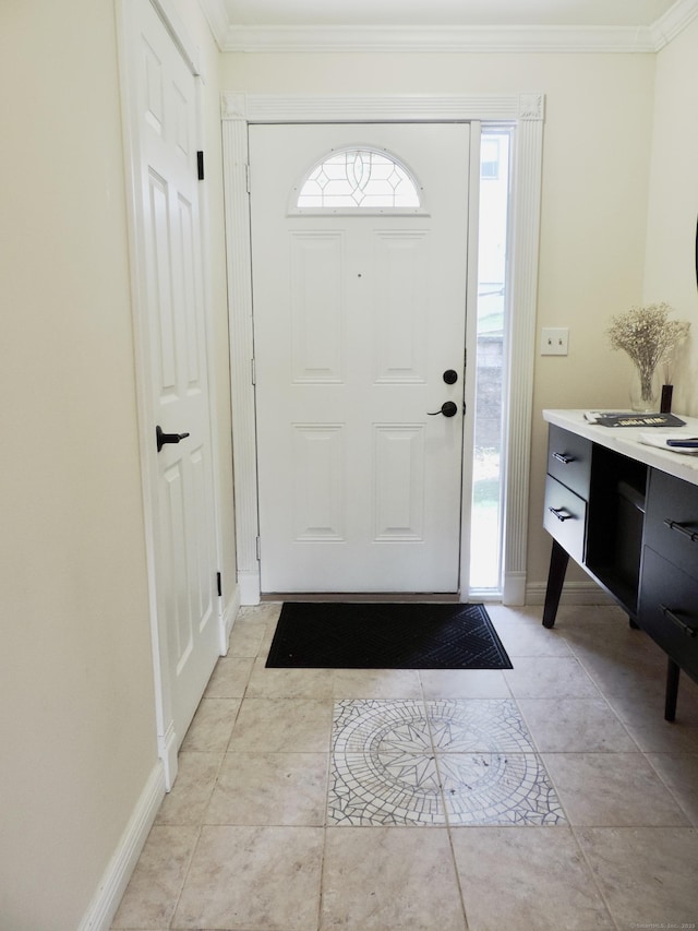foyer entrance with crown molding, a healthy amount of sunlight, and baseboards