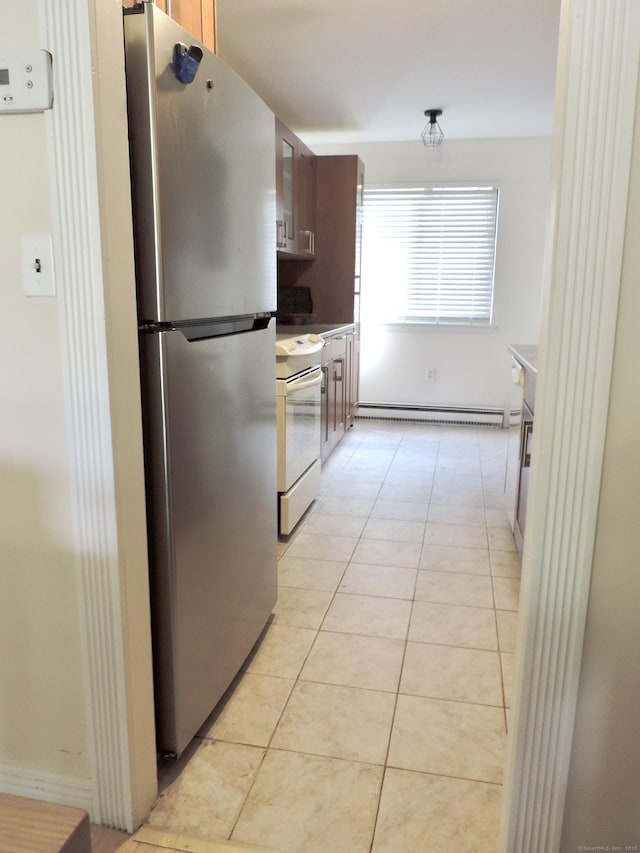 kitchen featuring light tile patterned floors, freestanding refrigerator, white electric stove, and baseboard heating