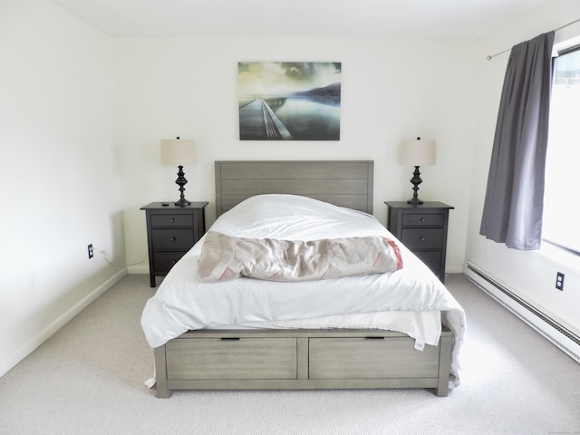 carpeted bedroom with baseboards and a baseboard radiator