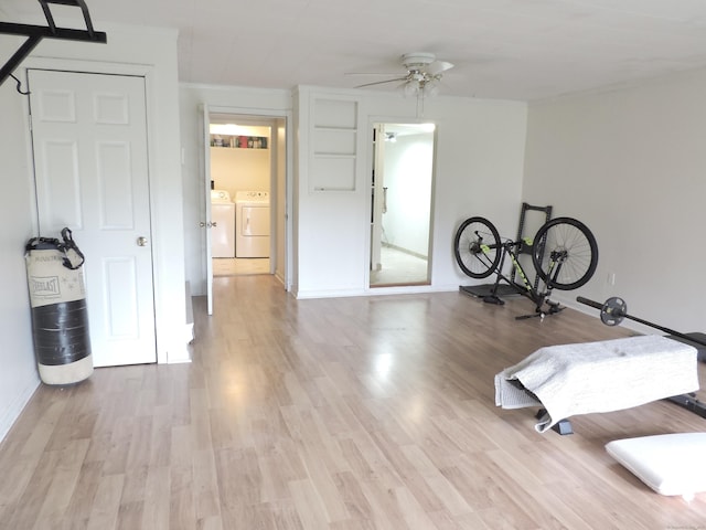 interior space with separate washer and dryer, baseboards, and wood finished floors