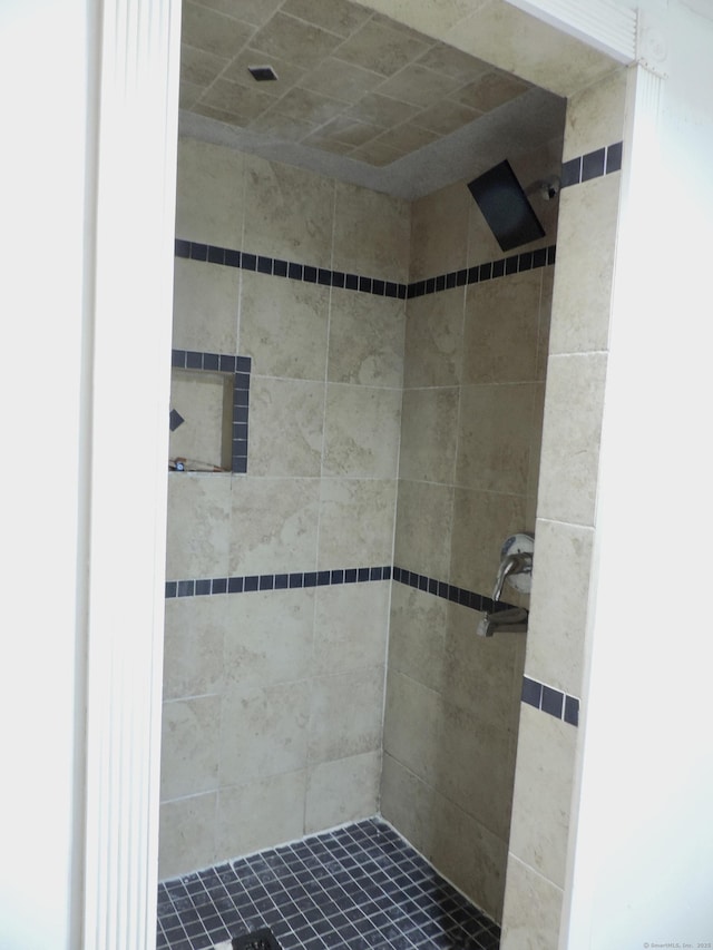 bathroom with a tile shower