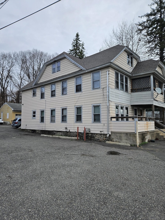 exterior space featuring a shingled roof