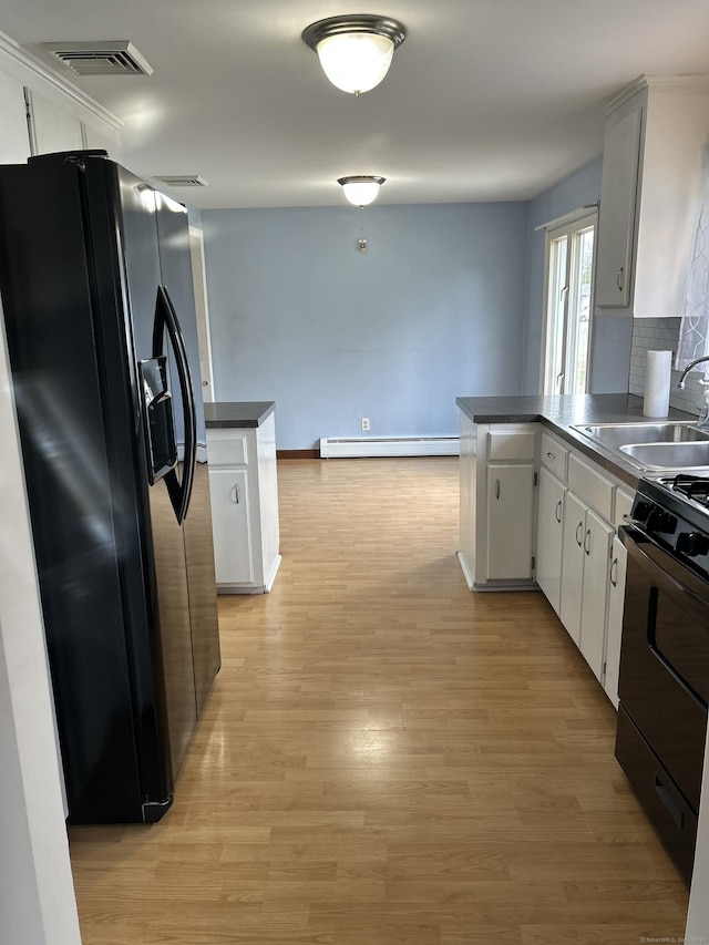 18 Nancy Dr, Enfield, CT 06082 - kitchen with a baseboard heating unit, a peninsula, black appliances, visible vents, and a sink