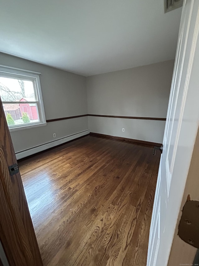 18 Nancy Dr, Enfield, CT 06082 - empty room featuring baseboard heating, dark wood-style flooring, baseboards, and visible vents