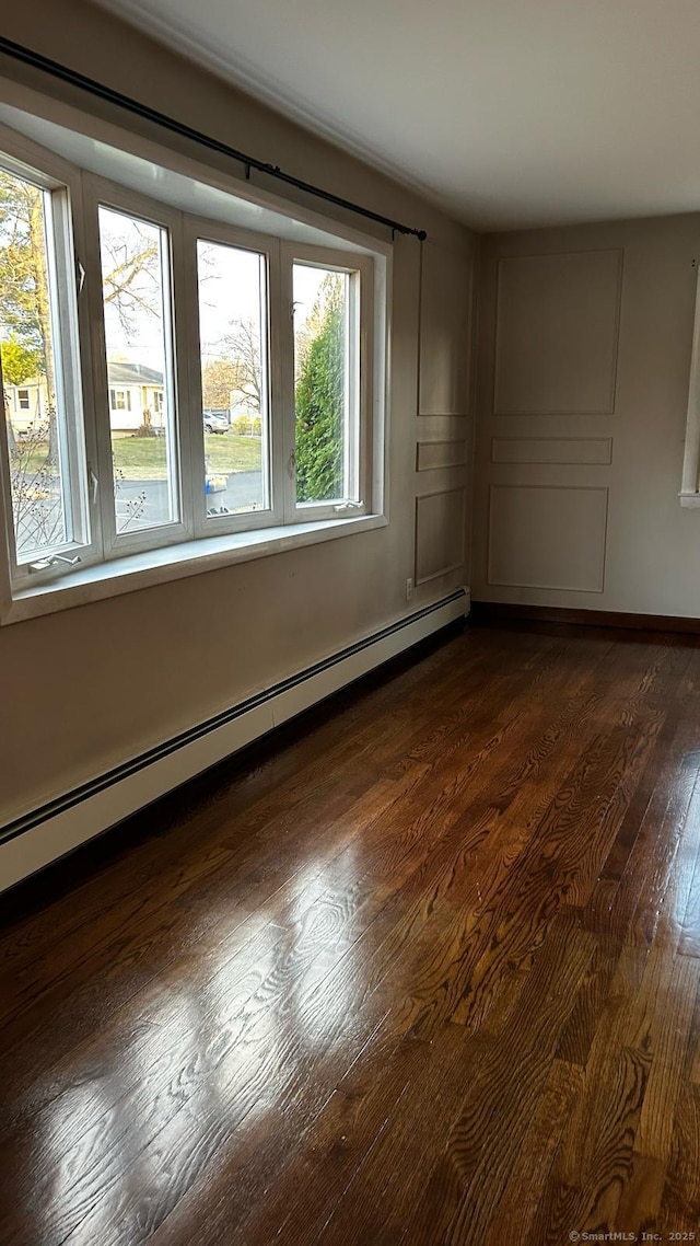 18 Nancy Dr, Enfield, CT 06082 - empty room with dark wood-type flooring, baseboards, and a baseboard heating unit