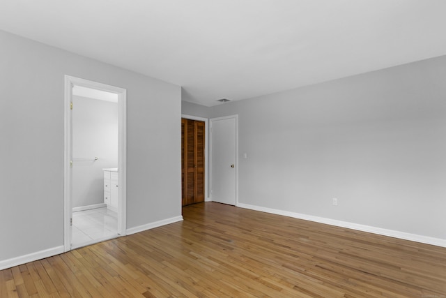 285 Greens Farms Rd, Westport, CT 06880 - unfurnished bedroom featuring light wood-style floors, baseboards, and connected bathroom