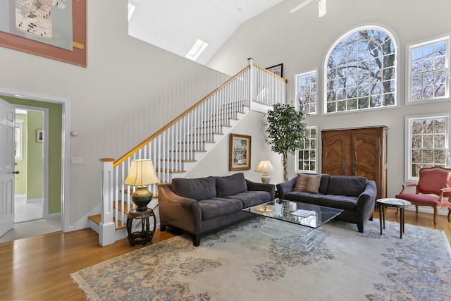 285 Greens Farms Rd, Westport, CT 06880 - living room featuring a high ceiling, stairway, wood finished floors, and baseboards