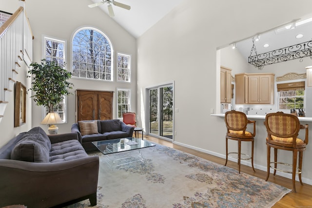 285 Greens Farms Rd, Westport, CT 06880 - living area featuring ceiling fan, high vaulted ceiling, light wood-style floors, baseboards, and rail lighting