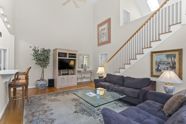 285 Greens Farms Rd, Westport, CT 06880 - living area featuring a towering ceiling, wood finished floors, baseboards, stairway, and a ceiling fan