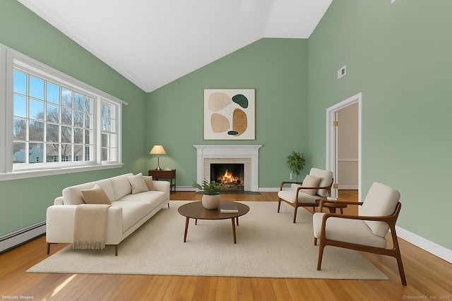 285 Greens Farms Rd, Westport, CT 06880 - living area featuring high vaulted ceiling, wood finished floors, a brick fireplace, baseboards, and a baseboard heating unit