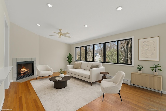 285 Greens Farms Rd, Westport, CT 06880 - living room with light wood-style flooring, a ceiling fan, a tile fireplace, recessed lighting, and a baseboard heating unit
