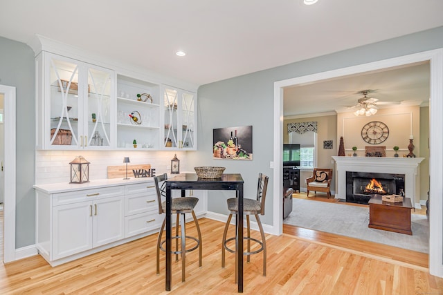 4 Shoreview Ln, Danbury, CT 06811 - bar with light wood-style floors, tasteful backsplash, recessed lighting, a fireplace with flush hearth, and a ceiling fan