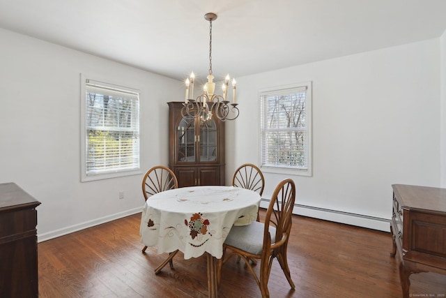 dining space featuring a baseboard heating unit, baseboards, a chandelier, and dark wood-type flooring