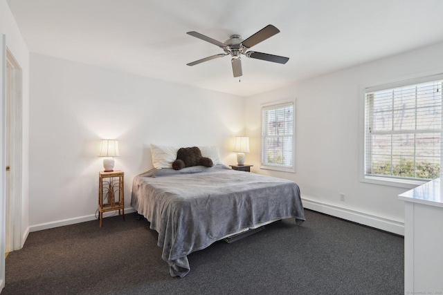 bedroom featuring baseboards, ceiling fan, dark carpet, and a baseboard radiator
