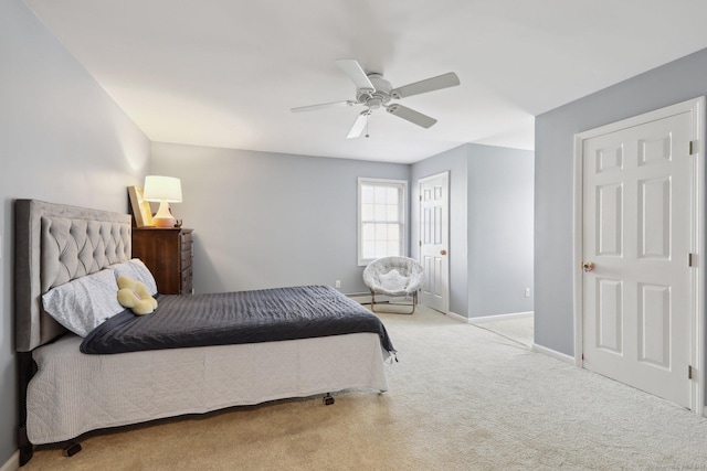 carpeted bedroom featuring baseboards and ceiling fan