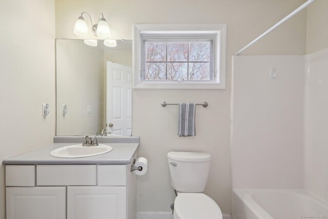 bathroom with toilet, tub / shower combination, and vanity