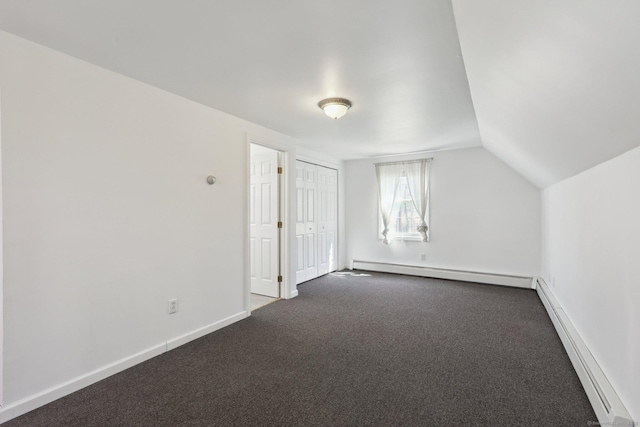 bonus room featuring baseboard heating, dark colored carpet, baseboards, and vaulted ceiling