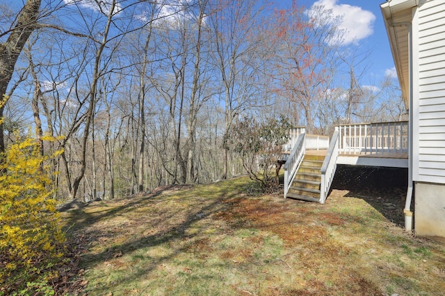 view of yard featuring a deck and stairs