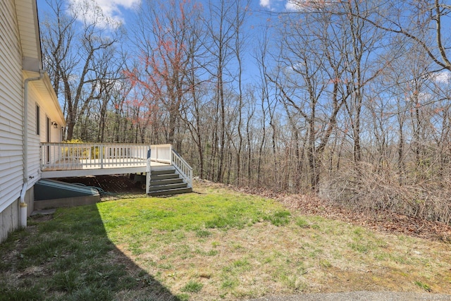 view of yard with a deck and a forest view