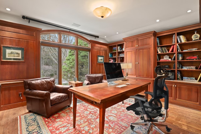 office space with wooden walls, recessed lighting, and light wood-style floors